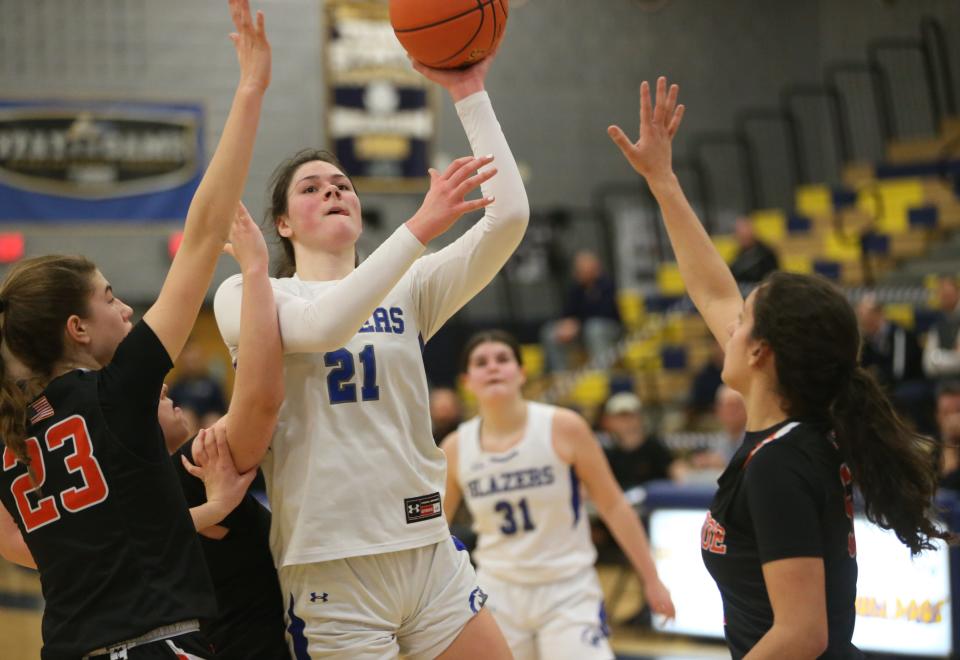 Millbrook's Natalie Fox takes a shot over Tuckahoe's, from left, Chloe Angelo and Cara Doherty during the New York State Class C regional final on March 7, 2024.