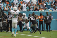 Miami Dolphins running back Myles Gaskin (37) gets past Atlanta Falcons safety Richie Grant (27) to score a touchdown, as Miami Dolphins wide receiver Mack Hollins (86) celebrates, during the second half of an NFL football game, Sunday, Oct. 24, 2021, in Miami Gardens, Fla. (AP Photo/Hans Deryk)