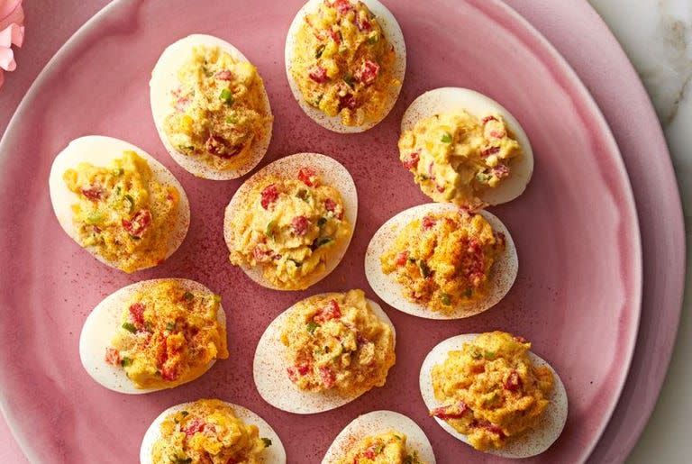 <p>These devilishly delicious appetizers come together thanks to shredded cheddar cheese, pimientos, mayonnaise and hot sauce. </p><p>Get the <strong><a href="https://www.goodhousekeeping.com/food-recipes/a37454/pimiento-cheese-deviled-eggs-recipe/" rel="nofollow noopener" target="_blank" data-ylk="slk:Pimiento-Cheese Deviled Eggs recipe;elm:context_link;itc:0;sec:content-canvas" class="link ">Pimiento-Cheese Deviled Eggs recipe</a></strong>. </p>