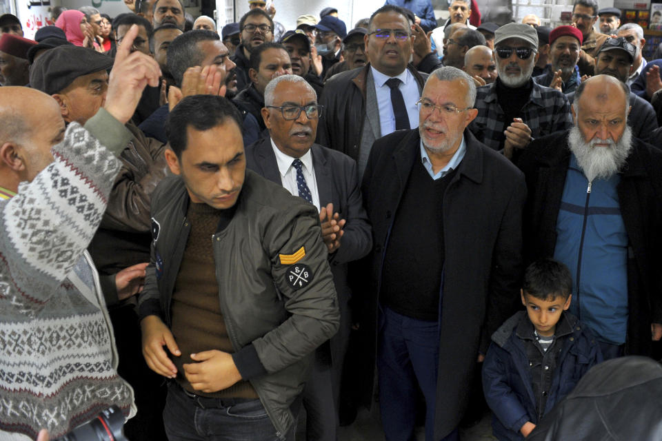 FILE - Supporters of the Tunisian Islamist movement Ennahda, with Noureddine Bhiri, second right, stage a protest in front of the justice ministry to denounce the arrest one of its senior leader in Tunis, Friday, Dec. 23, 2022. Tunisian authorities arrested the leader of the Ennahda opposition Islamist movement in a crackdown campaign on rival politicians and critics of the North African country's increasingly authoritarian president Kais Saied, according to lawyers. Noureddine Bhiri, a senior Ennahda leader, was taken into custody by armed police from his home in the capital, Tunis, late Monday FEB.13, 2023. (AP Photo/Hassene Dridi, File)