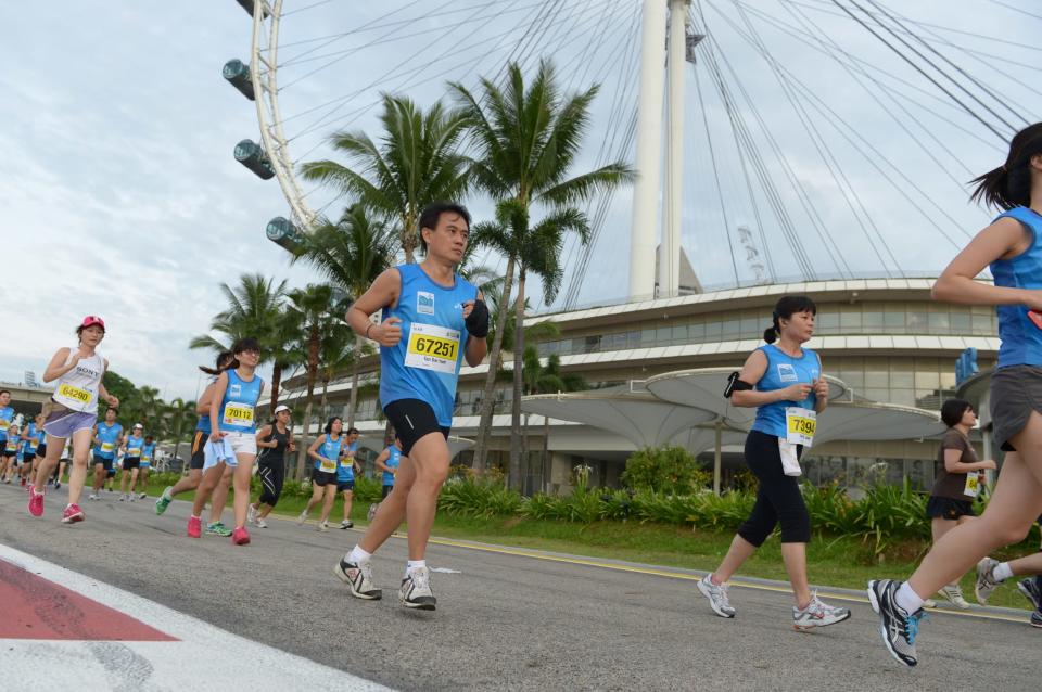 Runners running through Singapore’s iconic landmarks like the Singapore Flyer (Photo courtesy of Singapore Sports Council)