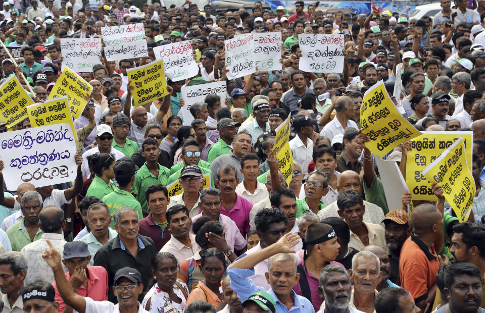 Supporters of the United National Party (UNP) and ousted Prime Minister Ranil Wickremesinghe protest against the government of disputed Prime Minister Mahinda Rajapaksa in Colombo, Sri Lanka, Thursday, Nov. 15, 2018. Sri Lanka has been in a crisis since Oct. 26, when President Maithripala Sirisena suddenly fired Wickremesinghe and replaced him with Rajapaksa. Sirisena had also suspended Parliament, apparently to allow Rajapaksa time to gather support among lawmakers. But Wickremesinghe insisted his firing was unconstitutional. He refused to vacate his official residence and demanded that Parliament be summoned to prove he still has support. (AP Photo/Rukmal Gamage)