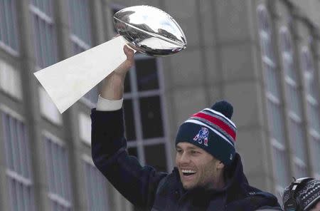Tom Brady, the New England Patriots quarterback and Super Bowl MVP, holds the Super Bowl trophy during the New England Patriots Super Bowl XLIX victory parade in Boston, Massachusetts February 4, 2015. REUTERS/Katherine Taylor