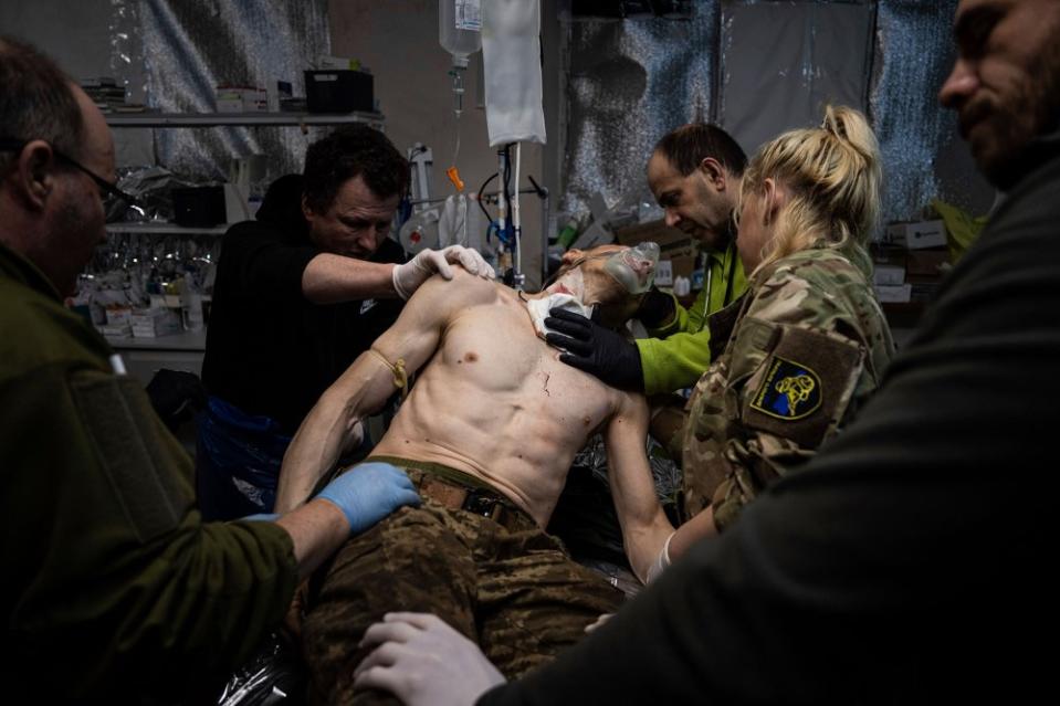 Ukrainian military medics treat their wounded comrade at a field hospital near Bakhmut, Ukraine, on Feb. 26.<span class="copyright">Evgeniy Maloletka—AP</span>