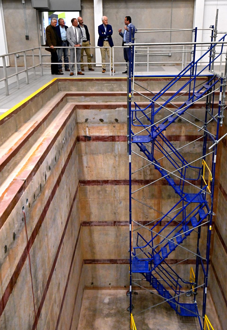 Rusty Towell, director of the  Nuclear Energy eXperimental Testing Lab, explains Tuesday to U.S. Sen. John Cornyn about the molten salt technology which will be employed in Abilene Christian University’s forthcoming nuclear research reactor. The pit before them is where the reactor will be installed.