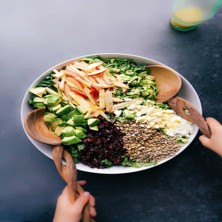 A big bowl of ingredients for Brussels sprouts salad.