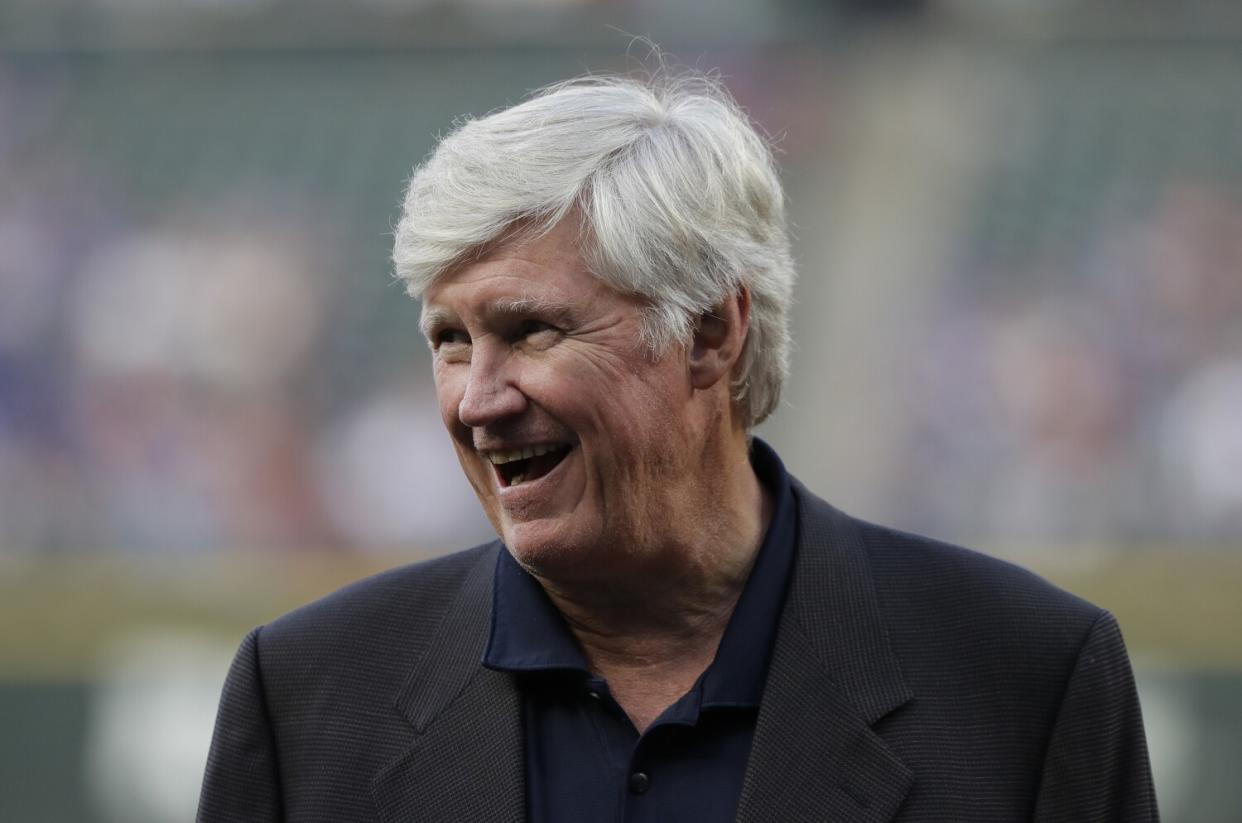 Seattle Mariners owner John Stanton stands on the field.