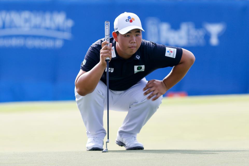 Joohyung Kim studies a putt on the 18th hole during Friday’s second round of the Wyndham Championship at Sedgefield Country Club.