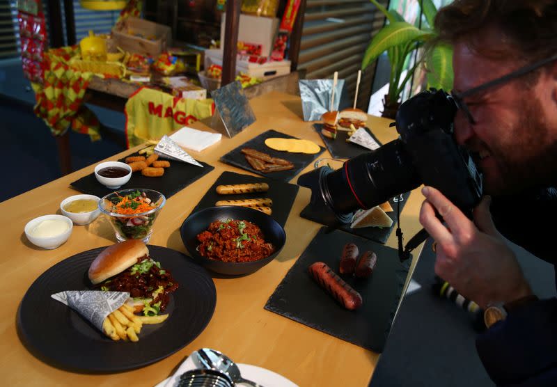 A photographer takes pictures of plant based vegetarian dishes during a media presentation at Nestle in Vevey