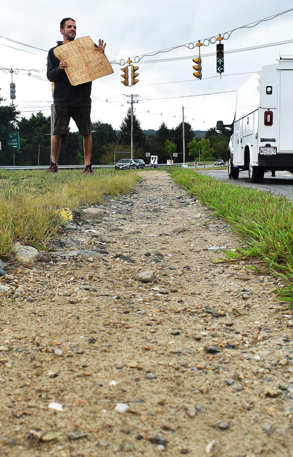 Steve panhandles on a well worn path at the corner of Route 6 and Father Devalles Boulevard in Fall River on Monday, Sept. 11, 2023.