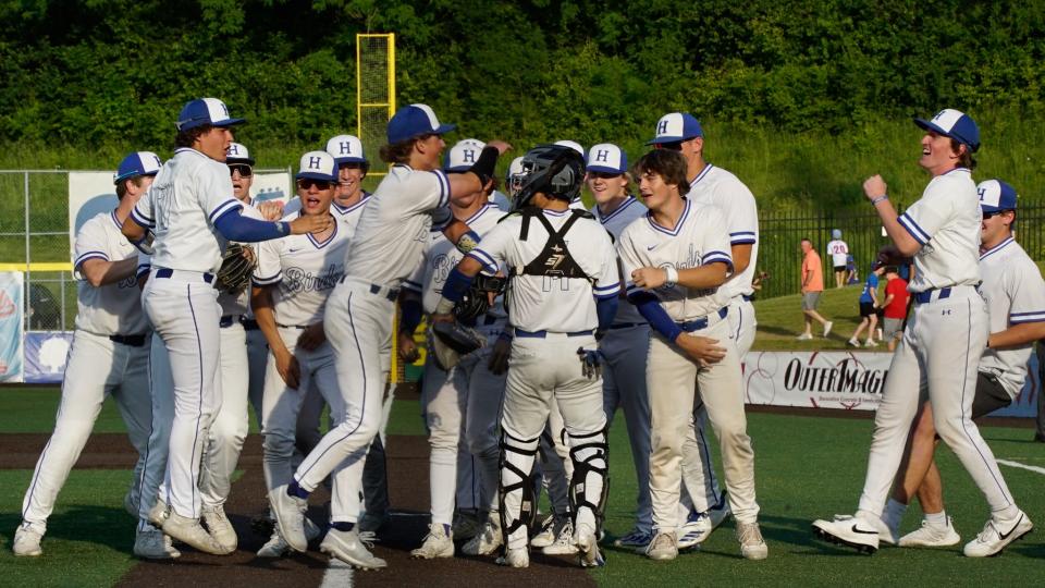 The Highlands Bluebirds celebrate around pitcher Jack Hendrix after defeating Conner 1-0 in the Ninth Region tournament semifinals at Thomas More Stadium on May 22, 2023.