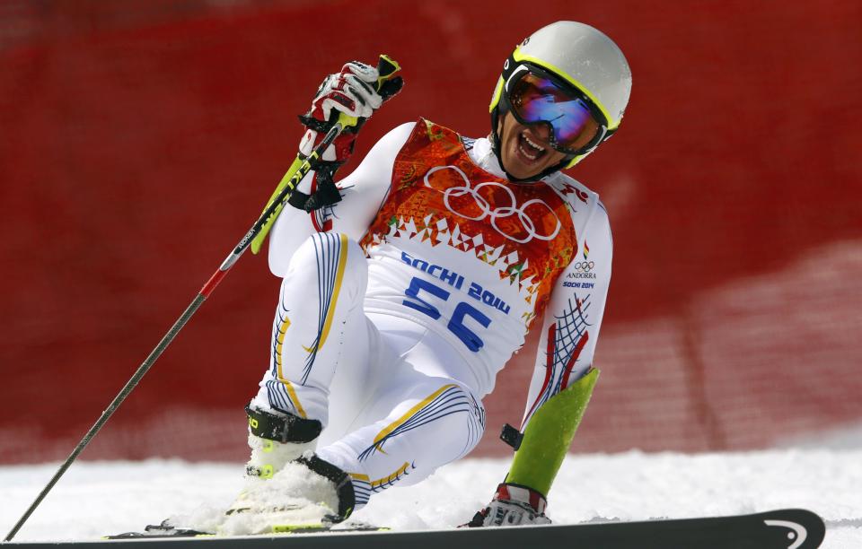 Andorra's Joan Verdu Sanchez laughs after crashing during the first run of the men's alpine skiing giant slalom event at the 2014 Sochi Winter Olympics at the Rosa Khutor Alpine Center February 19, 2014. REUTERS/Ruben Sprich (RUSSIA - Tags: SPORT SKIING OLYMPICS)