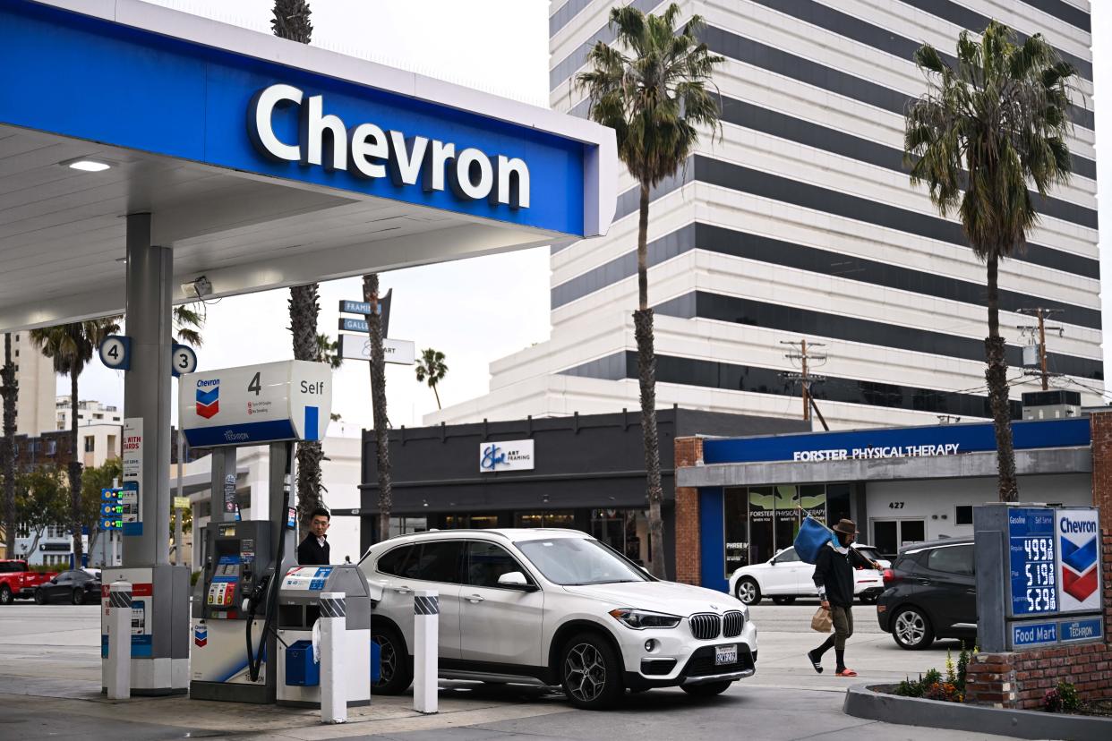 A customer pumps gasoline into a BMW vehicle at a Chevron gas station in Santa Monica, California on March 20, 2023. (Photo by Patrick T. Fallon / AFP) (Photo by PATRICK T. FALLON/AFP via Getty Images)