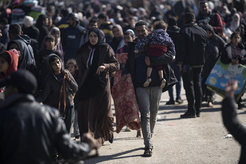 Palestinians arrive in the southern Gaza town of Rafah after fleeing an Israeli ground and air offensive in the nearby city of Khan Younis on Friday, Jan. 26, 2024. Israel has expanded its offensive in Khan Younis, saying the city is a stronghold of the Hamas militant group. (AP Photo/Fatima Shbair)