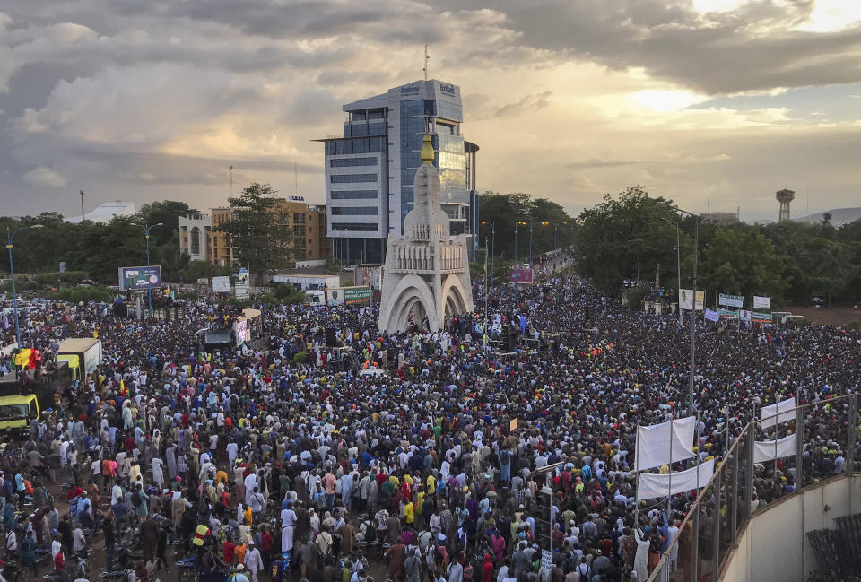 Malians supporting the recent overthrow of President Ibrahim Boubacar Keita gather to celebrate in the capital Bamako, Mali Friday, Aug. 21, 2020. Hundreds marched in the streets of Mali's capital Friday to celebrate the overthrow of Keita, as the West African country's longtime political opposition backed the military's junta plan to eventually hand over power to a civilian transitional government. (AP Photo/Baba Ahmed)