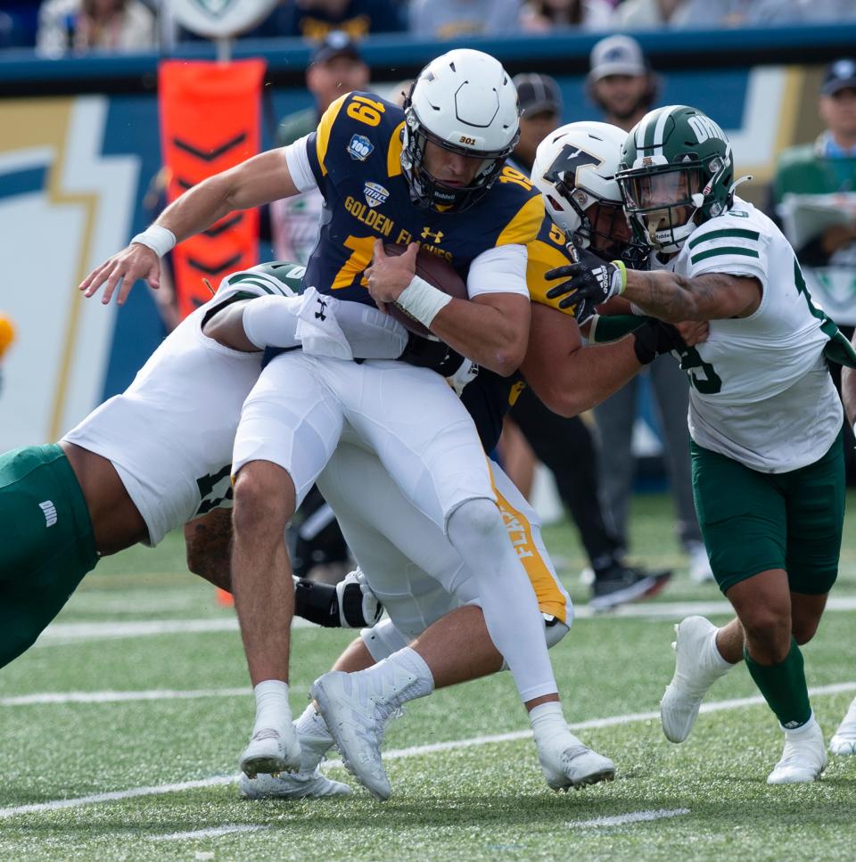 Kent State quarterback Collin Schlee is corralled by several Ohio defenders during Saturday's game at Dix Stadium.