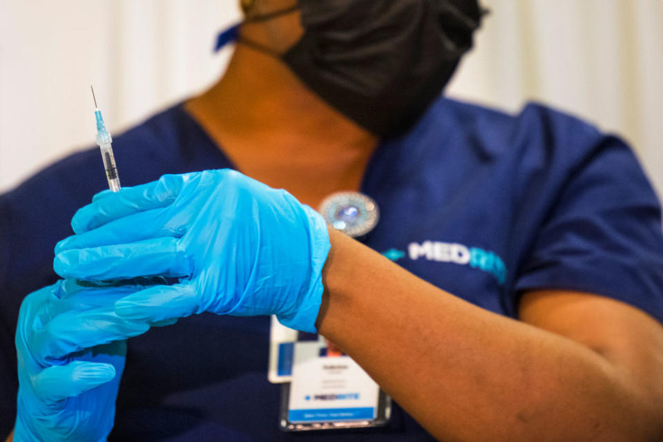 A medical staffer prepares a dose of the coronavirus vaccine.