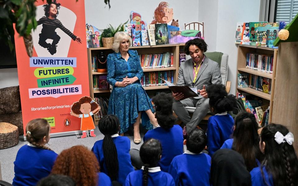 Queen Camilla and pupils listen to Waterstones Children's Laureate and poet Joseph Coelho reading a poem in the new library
