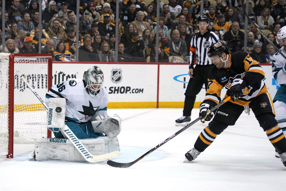 San Jose Sharks goaltender Kaapo Kahkonen (36) blocks a shot by Pittsburgh Penguins' Bryan Rust (17) during the second period of an NHL hockey game in Pittsburgh, Saturday, Jan. 28, 2023. (AP Photo/Gene J. Puskar)