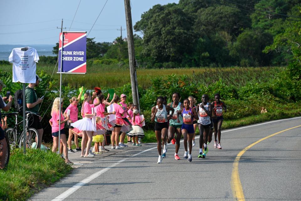 Elite Women's first place winner Hellen Obiri takes the lead while passing the Trunk River cheer zone at the 51st Falmouth Road Race.

Kyle Kaldy/Cape Cod Times