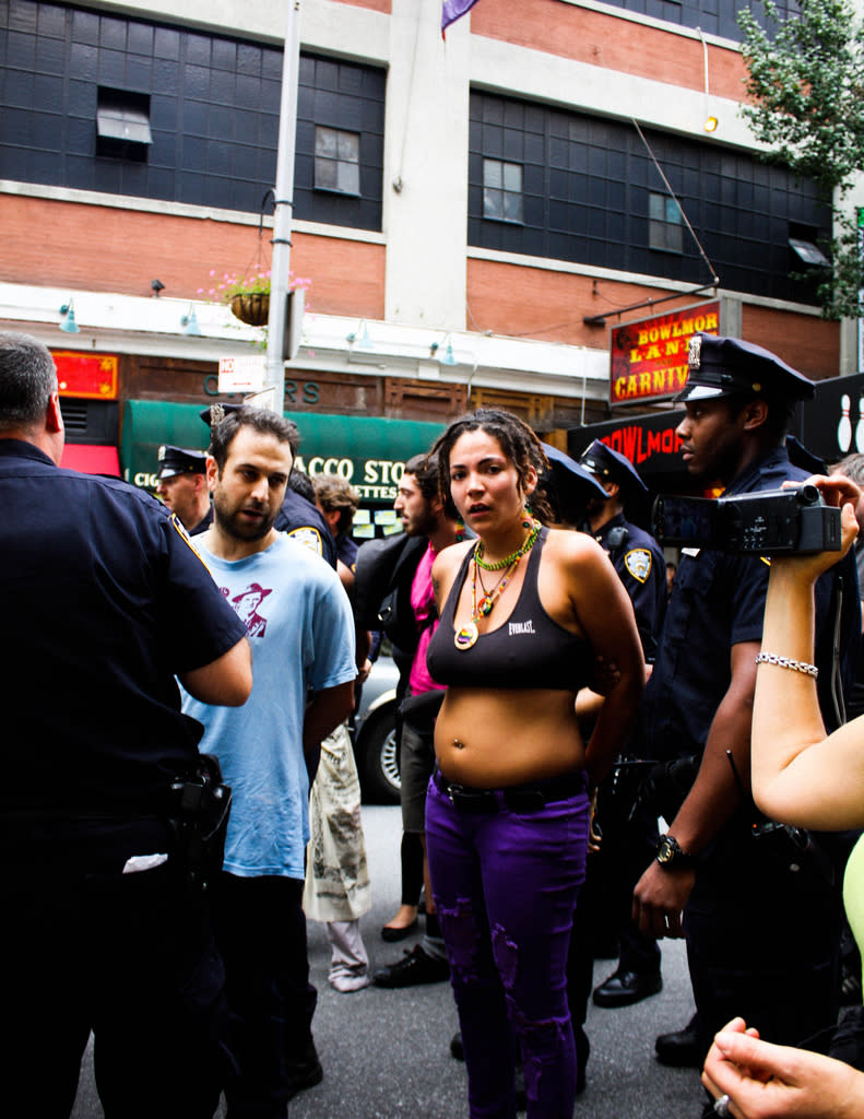 Two protesters are filmed while talking with cops