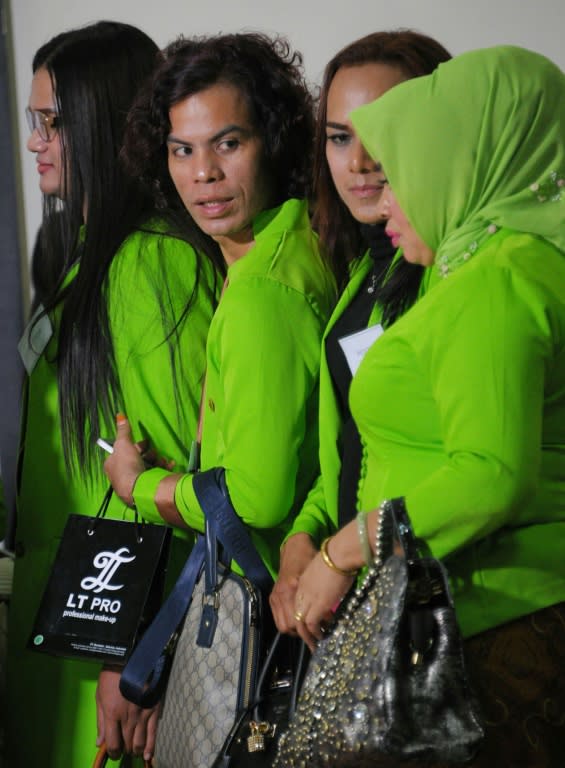 Transvestites who work as make-up artist lining up during beauty contest event in Banda Aceh