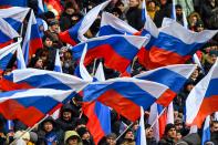 <p>Supporters of presidential candidate, President Vladimir Putin gather for a pre-election rally at the Luzhniki stadium in Moscow on March 3, 2018. (Photo: Kirill Kudryavtsev/AFP/Getty Images) </p>