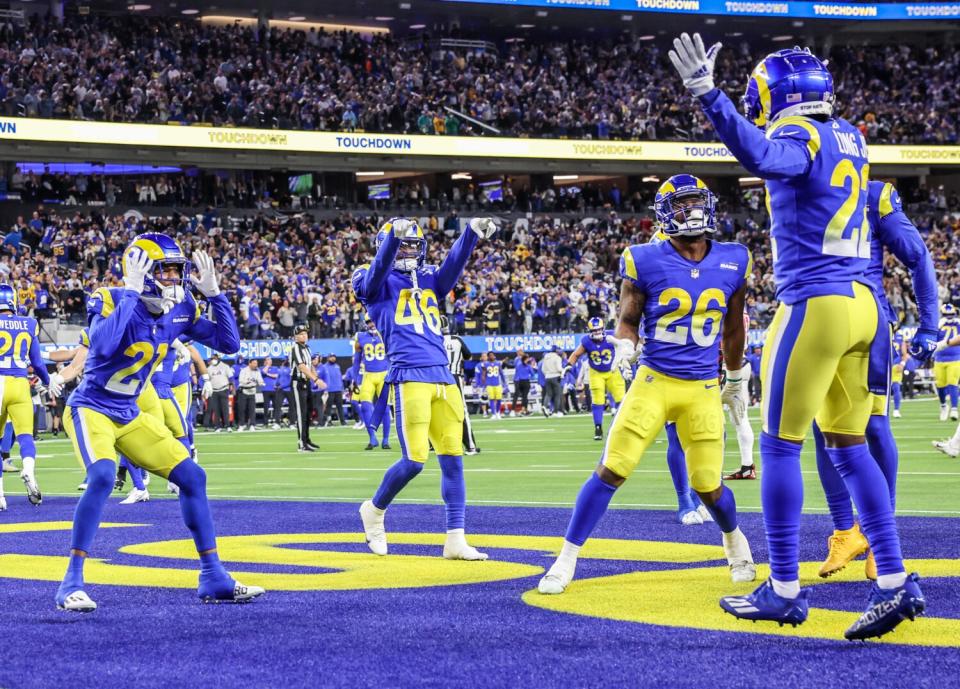 Rams defensive back David Long celebrates with teammates after scoring on a pick-six.