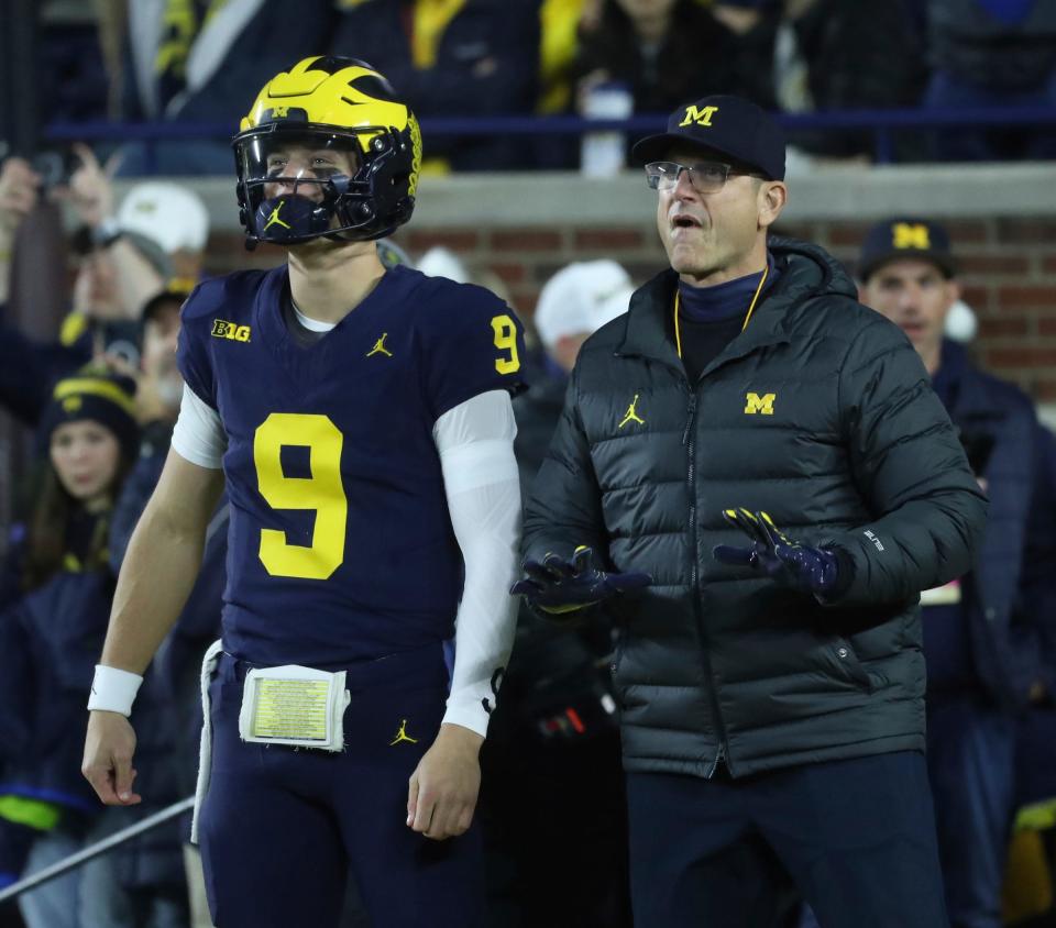 Michigan Wolverines quarterback J.J. McCarthy and coach Jim Harbaugh before action against the Purdue Boilermakers at Michigan Stadium, Saturday, Nov. 4, 2023.