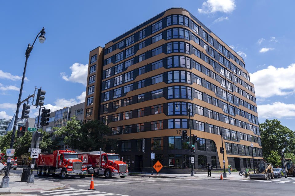 Construction vehicles are parked outside of the Station U & O building on Tuesday, June 11, 2024, in Washington. The apartment building was built using investments from Amazon's Housing Equity Fund. The company said Tuesday its adding $1.4 billion to the fund in order to help preserve or construct more affordable housing units in three regions. (AP Photo/Jacquelyn Martin)