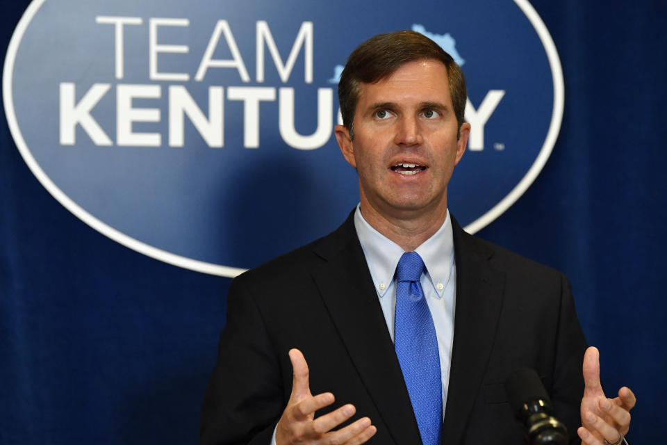 Kentucky Governor Andy Beshear speaks to reporters before the signing of bills related to the American Rescue Plan Act at the Kentucky State Capitol in Frankfort, Ky., Wednesday, April 7, 2021. (AP Photo/Timothy D. Easley)