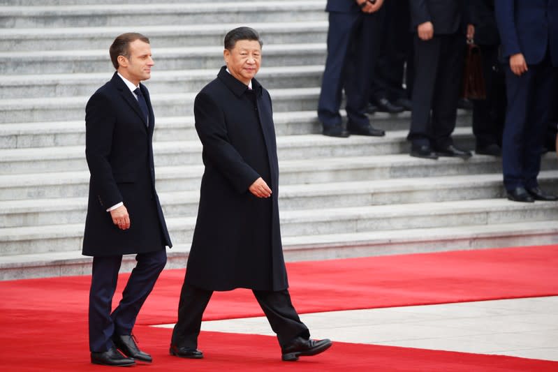 French President Emmanuel Macron attends a welcome ceremony with Chinese President Xi Jinping outside the Great Hall of the People in Beijing