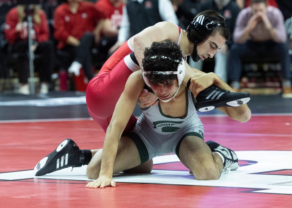 Dean Peterson (left), shown during his win over Michigan State's Tristan Lujan on Friday night, began Rutgers' match with Michigan with a 3-1 win over Jack Medley on a takedown with 12.9 seconds remaining.