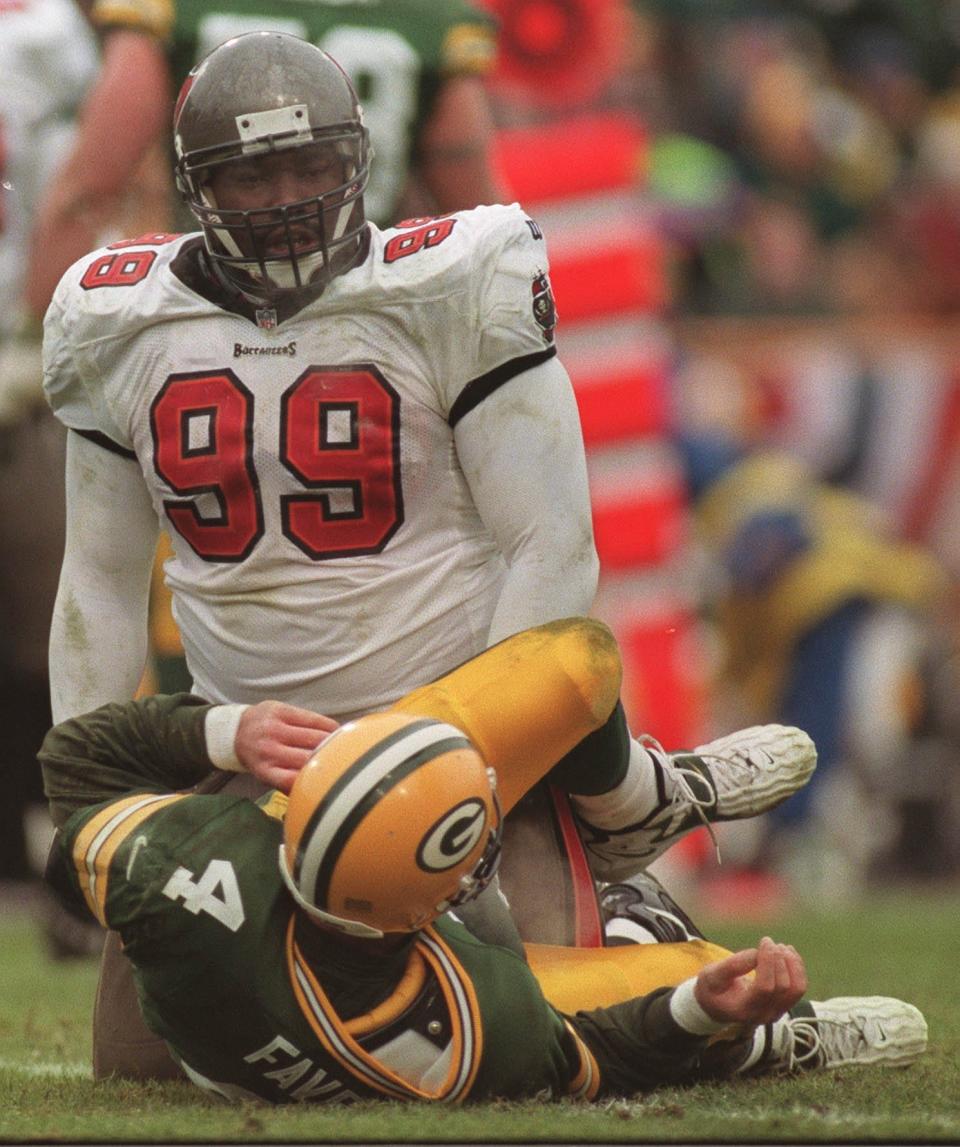 Tampa Bay standout defensive tackle Warren Sapp exhcnages words with Green Bay Packers quarterback Brett Favre after putting pressure on him during the third quarter of their game Sunday, January 4, 1998 at Lambeau Field in Green Bay, Wis.