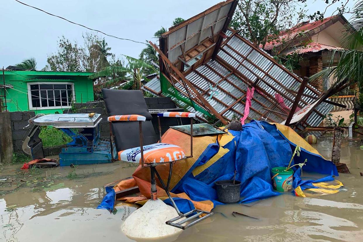 A destroyed house lies on its side after tropical storm Molave hit the town of Pola, Oriental Mindoro province (AFP via Getty Images)