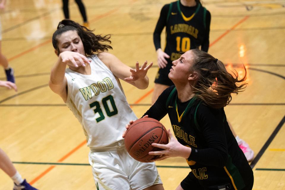 Archbishop Wood sophomore Emily Knouse looks to block Lansdale Catholic senior Gabby Casey at Archbishop Wood High School on Tuesday, Feb. 7, 2023. The Crusaders defeated the Vikings 49-31.