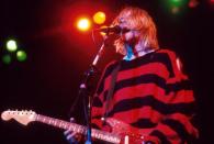 <p>Kurt Cobain performs on stage in 1993. His oversized baggy sweater was a staple of the grunge look popular in the early '90s.</p>