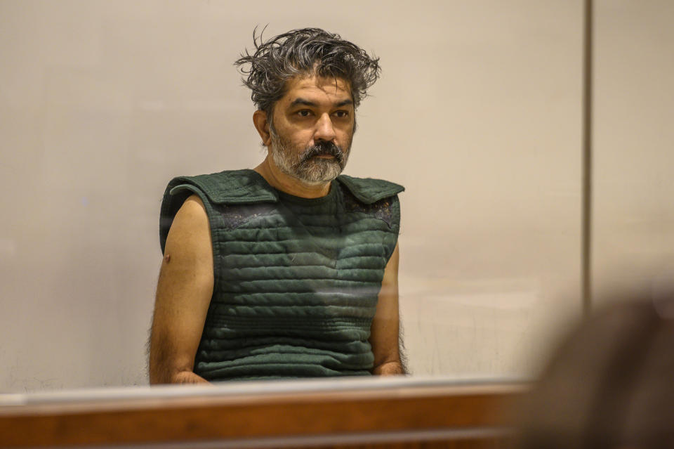 Shankar Hangud, wearing a personal safety vest, appears in the Placer County Superior Court Wednesday, Oct. 16, 2019, in Roseville, Calif. Prosecutors say Hangud faces murder charges for allegedly killing four members of his family in Northern California. (Renee C. Byer/The Sacramento Bee via AP, Pool)