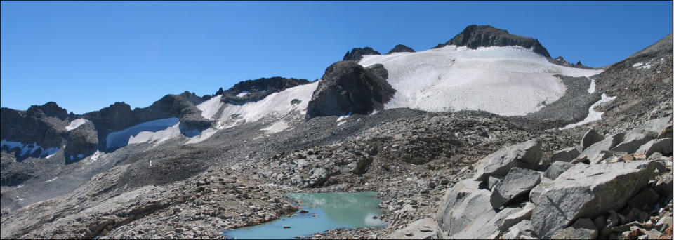 In this Sept. 5, 2004 photo provided by Hassan Basagic is Lyell Glacier in Yosemite National Park. In parts of California’s Sierra Nevada, the incursion of trees is sucking marshy meadows dry. Glaciers are melting into mere ice fields. Wildflowers are blooming earlier. And the optimal temperature zone for Giant Sequoias is predicted to rise several thousand feet higher, leaving existing trees at risk of dying over the next 100 years. As the climate warms, scientists studying one of the largest swaths of wilderness in the Continental U.S. are noting changes across national parks, national forests and 3.7 million acres of federally protected wilderness areas that are a living laboratory. (AP Photo/Hassan Basagic)