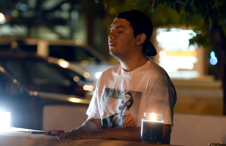 A man prays outside the Scottsdale Healtcare Hospital where boxing legend Muhammad Ali passed away, in Phoenix, Arizona on June 4, 2016