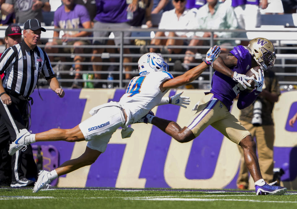 Washington wide receiver Ja'Lynn Polk pulls in a long pass next to Boise State cornerback Kaonohi Kaniho during the second half of an NCAA college football game Saturday, Sept. 2, 2023, in Seattle. AP Photo/Lindsey Wasson)