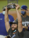 Los Angeles Dodgers pitcher Clayton Kershaw celebrates with the trophy after defeating the Tampa Bay Rays 3-1 to win the baseball World Series in Game 6 Tuesday, Oct. 27, 2020, in Arlington, Texas. (AP Photo/Eric Gay)