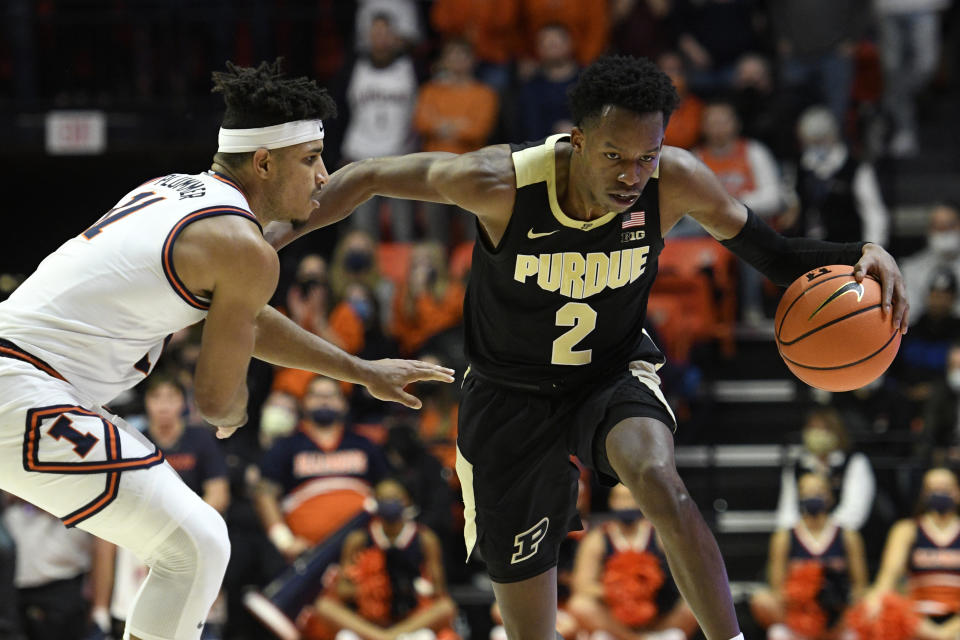 Purdue's Eric Hunter Jr. (2) runs up the court as Illinois' Alfonso Plummer defends during the second half of an NCAA college basketball game, Monday, Jan. 17, 2022, in Champaign, Ill. (AP Photo/Michael Allio)