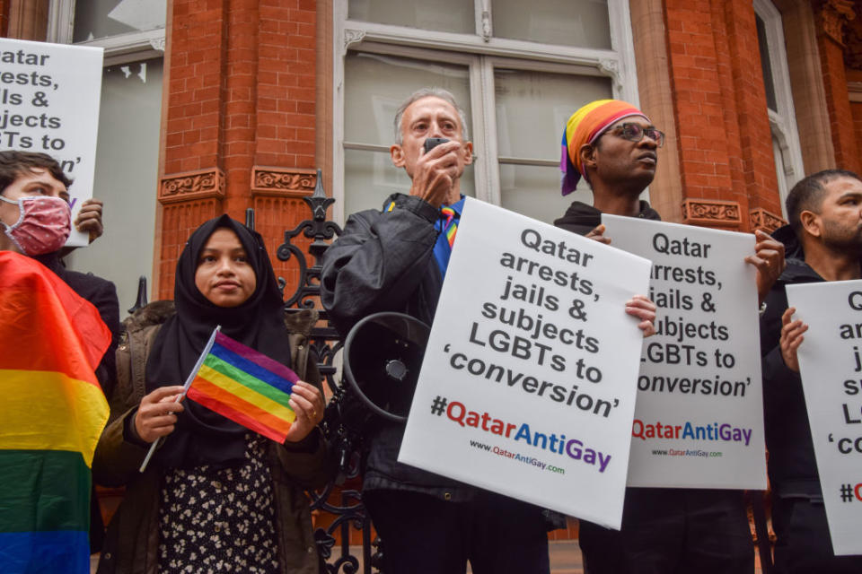 Activist Peter Tatchell holds a placard which states 'Qatar