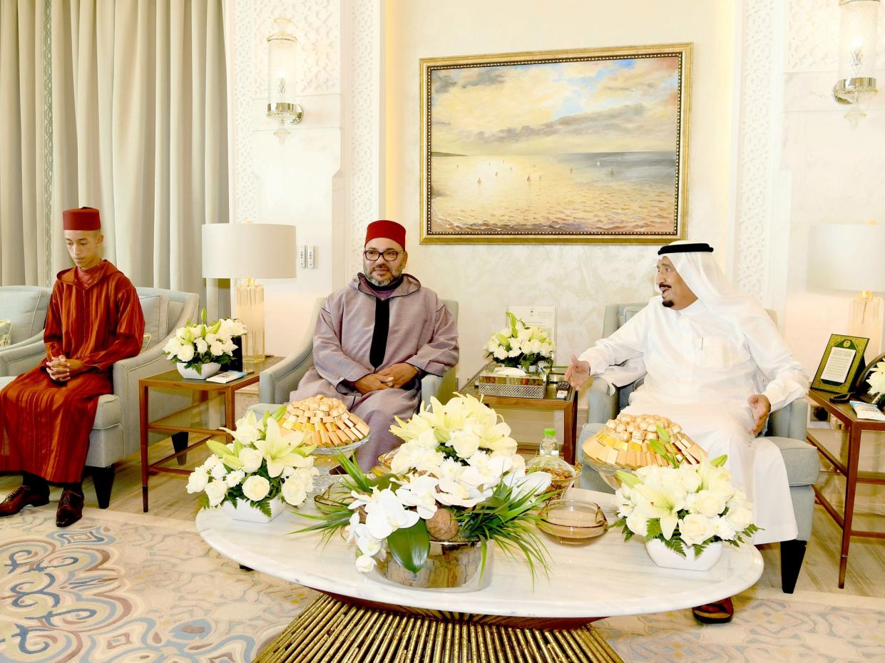 King Mohammed VI, center, is flanked by the Crown Prince Moulay Hassan, left, during a courtesy visit to Saudi King Salman in his residence in Tangier, northern Morocco: AP