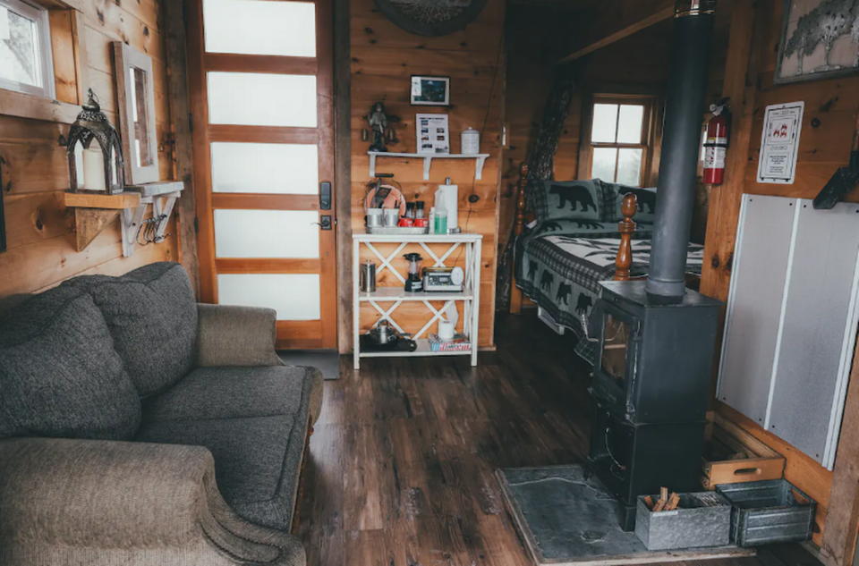 The Off-The-Grid Treehouse has a deck, outdoor kitchenette and outdoor dining area.