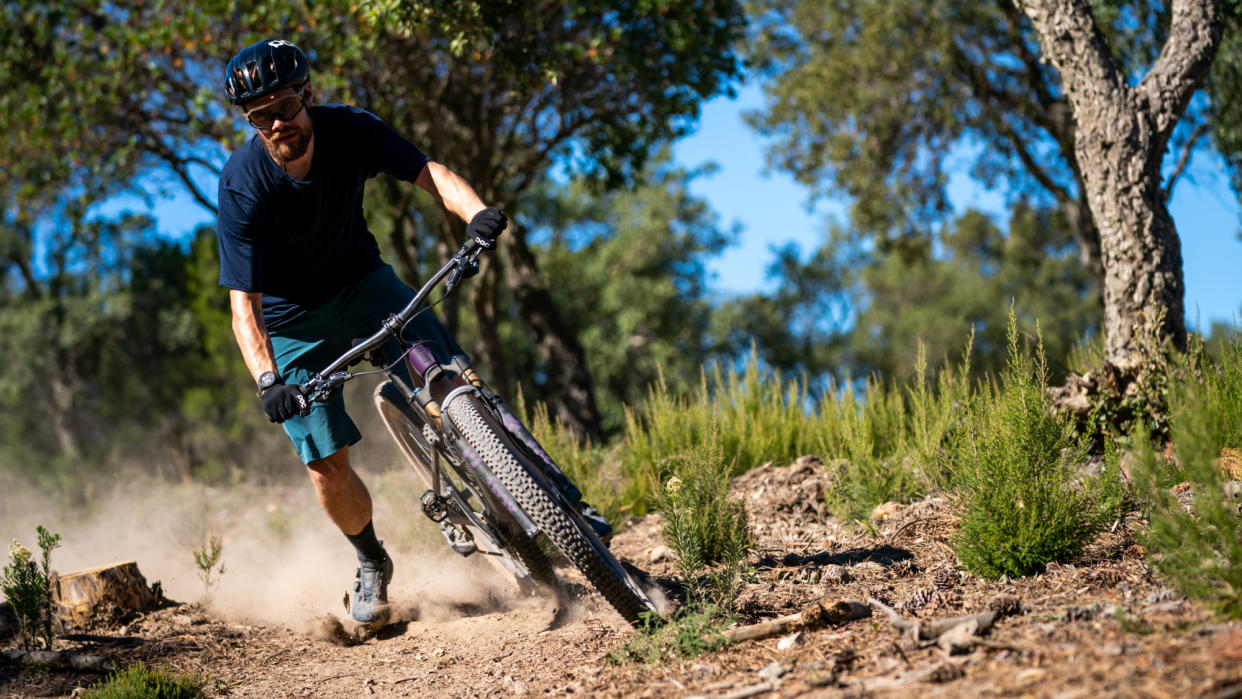  Graham Cottingham riding a dusty corner on a mountain bike. 