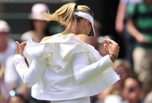 Russia's Maria Sharapova takes off her training top before her match against Bulgaria's Tsvetana Pironkova on Thursday. Sharapova had crushed Anastasia Rodionova in the first round in her first match since winning the French Open earlier this month, but Pironkova made the Russian fight far harder to keep her title bid on course