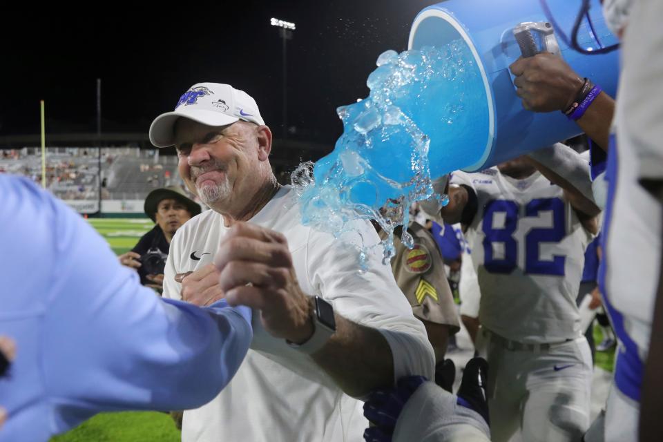 Middle Tennessee head coach Rick Stockstill is dowsed after his team defeated San Diego State 25-23 at the Hawaii Bowl NCAA college football game, Saturday, Dec. 24, 2022, in Honolulu. (AP Photo/Marco Garcia)