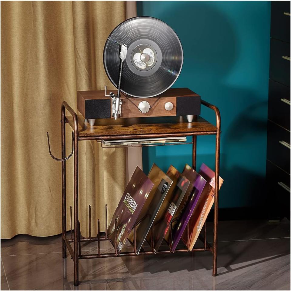 brown and bronze record player stand with turntable and vinyls on it